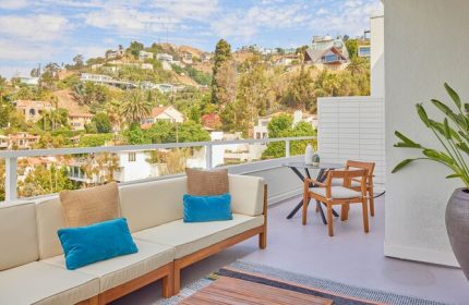 Andaz West Hollywood gay-friendly hotel balcony view. Outdoor seating, hills, and blue sky. Perfect for gay travel and relaxation.