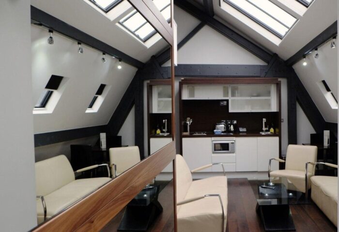 Roomzzz Manchester City Aparthotel's gay-friendly room: loft apartment with kitchenette, skylights, and modern furniture. Great for gay travelers.