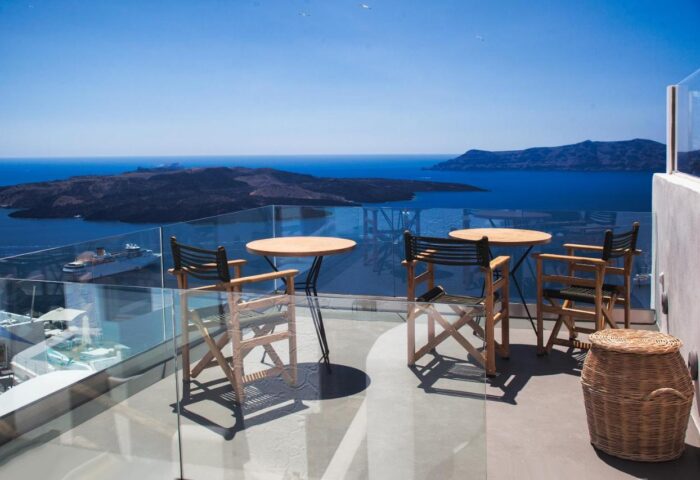 Aperto Suites Adults Only gay-friendly hotel balcony view. Tables and chairs overlook the sea. Ideal for gay men's travel.