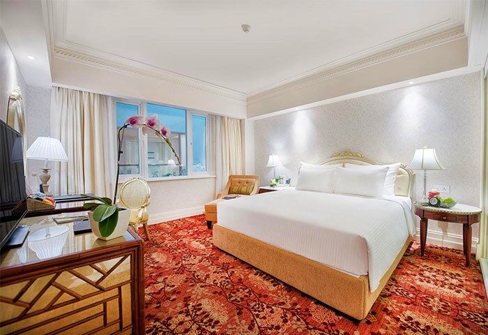 Apricot Hotel's gay-friendly room. Upscale interior with king bed, desk, and floral accents. A comfortable stay for gay travelers.