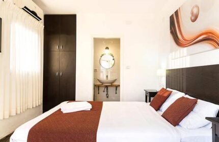 Arbel Suites Hotel room. Gay-friendly hotel with bed, pillows, and bathroom. Modern design, clean, and comfortable. Ideal for gay travelers.