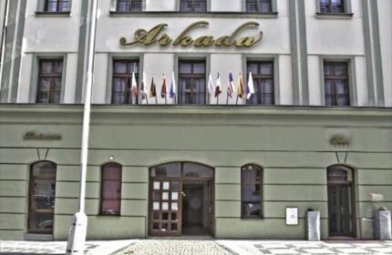 Facade of Arkada Hotel Praha, a gay-friendly hotel. Flags displayed above entrance. Good choice for gay men traveling to Prague.