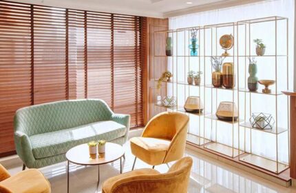 Armon Hayarkon Hotel's stylish lounge area. Gay-friendly hotel with modern furniture, decorative shelving, and inviting seating. Perfect for gay travelers.