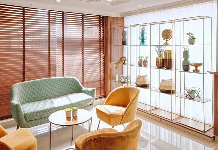 Armon Hayarkon Hotel's stylish lounge area. Gay-friendly hotel with modern furniture, decorative shelving, and inviting seating. Perfect for gay travelers.