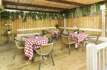 Armon Hayarkon Hotel's charming outdoor dining area. A gay-friendly hotel with tables set for a relaxing meal. Perfect for gay travel.