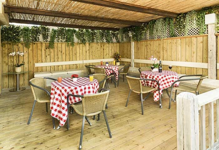 Armon Hayarkon Hotel's charming outdoor dining area. A gay-friendly hotel with tables set for a relaxing meal. Perfect for gay travel.