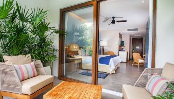 Armony Resort & Spa All Inclusive Adults Only future MGallery gay-friendly hotel room with balcony, seating area, and view of the bedroom.