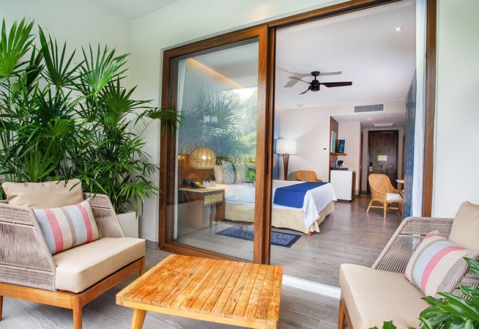 Armony Resort & Spa All Inclusive Adults Only future MGallery gay-friendly hotel room with balcony, seating area, and view of the bedroom.