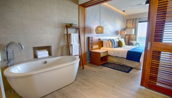 Armony Resort & Spa All Inclusive Adults Only MGallery gay-friendly hotel room. Bathtub, bedroom, and ocean view. Luxury travel.
