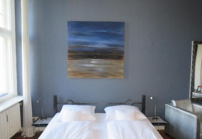 ArtHotel Connection gay-friendly room. Pet-friendly hotel with art. Bedroom with painting above the bed. Gay men travel advice.