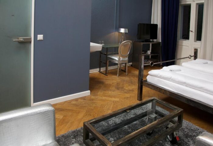ArtHotel Connection gay-friendly hotel room. Desk, TV, and bed. Pet-friendly lodging with modern design. Travel advice for gay men.