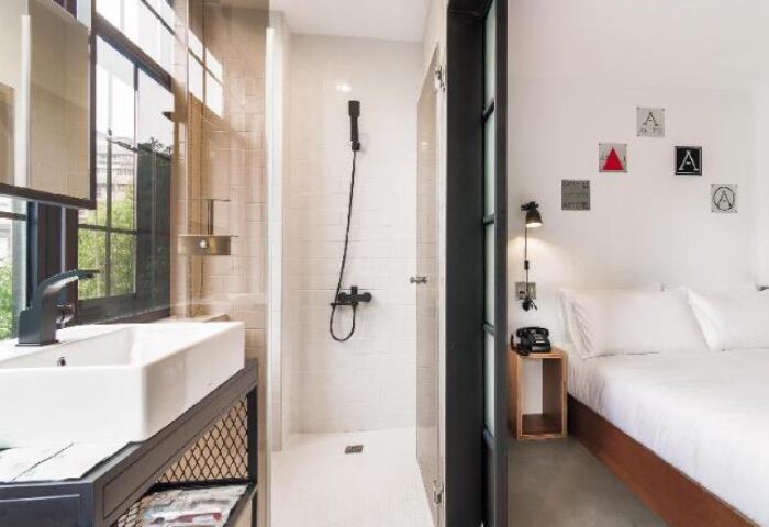 Art'otel Ximending Taipei gay-friendly hotel room. Modern design with shower, sink, and bed. Stylish decor in this Ximending hotel.