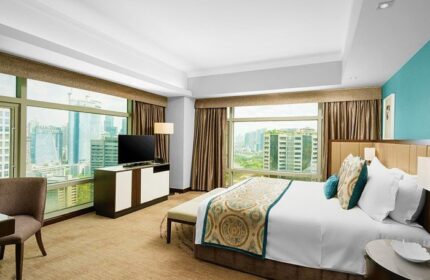 Bedroom at Ascott Makati, a gay-friendly hotel. City view from large windows. Modern design, comfortable bed. Perfect for gay travel in Makati.