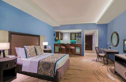 Ascott Makati gay-friendly hotel room. Bedroom with bed, desk, and kitchenette. Gay travel in Makati, Philippines. Luxury hotel suite.