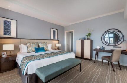 Ascott Makati gay-friendly hotel room. King bed with blue accents, desk, and modern decor. Comfortable and stylish accommodations for gay travelers.