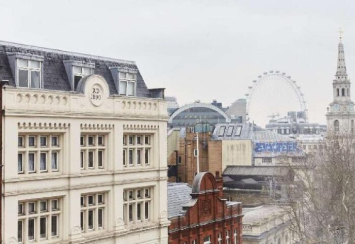 Assembly Hotel, a gay-friendly hotel. Skyline view with the London Eye, old buildings, and church tower. Travel advice for gay men in London.