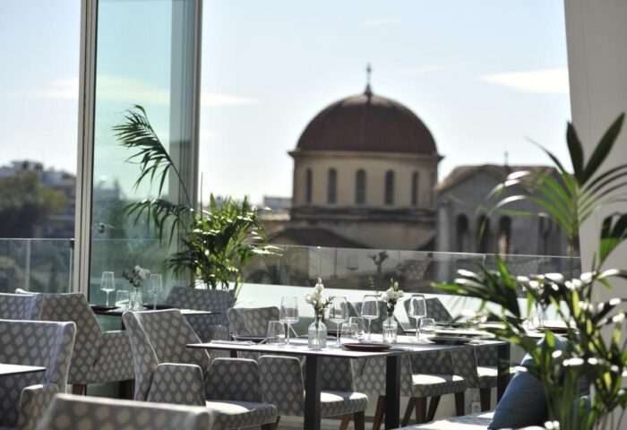 Athenaeum Eridanus Luxury Hotel's gay-friendly rooftop restaurant in Athens. Tables are set with city views. Perfect for gay travelers.
