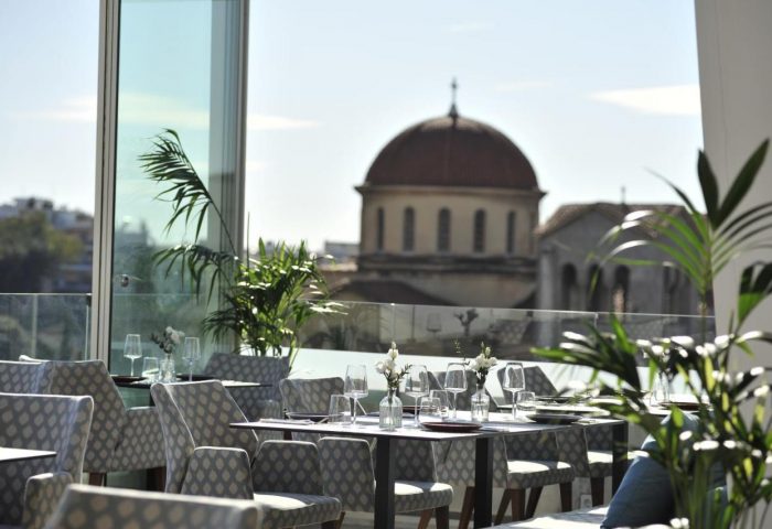 Athenaeum Eridanus Luxury Hotel's gay-friendly rooftop restaurant in Athens. Tables are set with city views. Perfect for gay travelers.