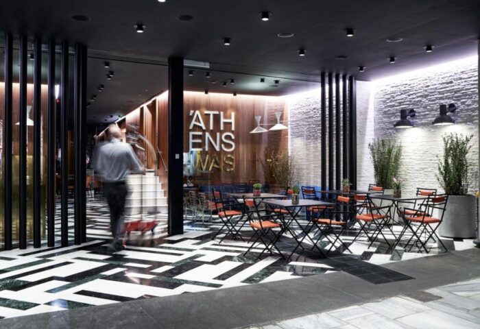 AthensWas Hotel entrance. Gay-friendly hotel features stylish outdoor seating, black and white patterned floors, and modern design.