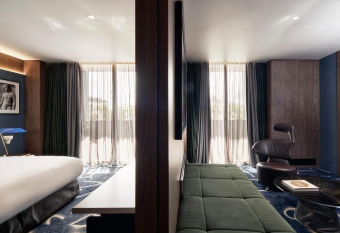 AthensWas Hotel room, gay-friendly travel. Modern design, bed, couch, chair, and art. Luxury hotel for gay men in Athens, Greece.