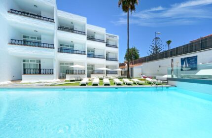 Atlantic Sun Beach gay men only hotel. Exterior view of the gay-friendly hotel with pool, sunbeds, and balconies on a sunny day.