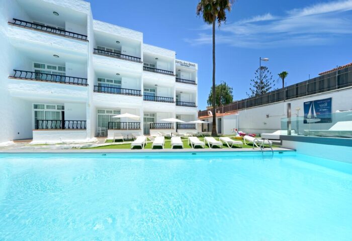 Atlantic Sun Beach gay men only hotel. Exterior view of the gay-friendly hotel with pool, sunbeds, and balconies on a sunny day.