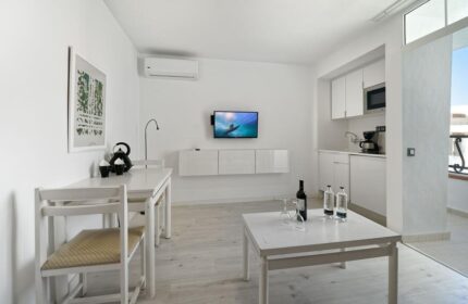 Atlantic Sun Beach gay-friendly hotel room. Interior of a bright apartment with white furniture, kitchenette, and balcony. Gay men only.