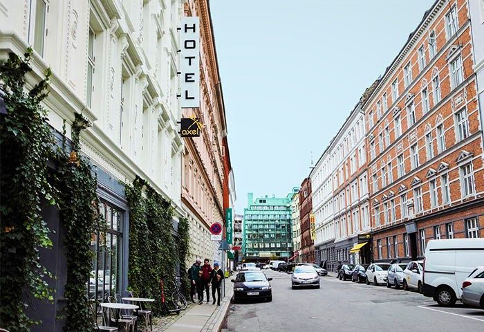 Axel Guldsmeden, a gay-friendly hotel. Street view of the Axel Guldsmeden Hotel. The hotel's sign is visible, and the building is covered in ivy.