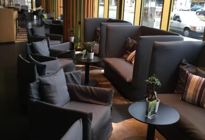 Axel Hotel Berlin Adults Only: Gay-friendly hotel lounge area with comfortable seating, tables, and a view of the city street. Modern design.