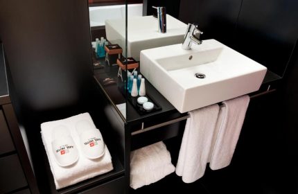 Axel Hotel Berlin Adults Only: Bathroom detail with sink, towels & slippers. Gay-friendly hotel room. Modern design. Perfect for gay travel.