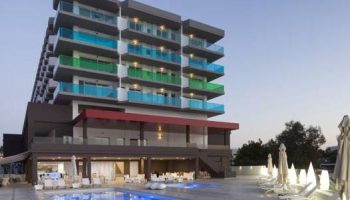 AxelBeach Ibiza Suites, an adults-only gay-friendly hotel. Poolside view of the apartments, spa, and beach club. Perfect for gay travel.