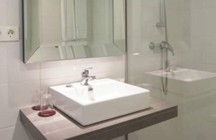 AxelBeach Ibiza bathroom. Modern sink, mirror, and shower in this gay-friendly, adults-only suite. Perfect for a relaxing spa getaway.