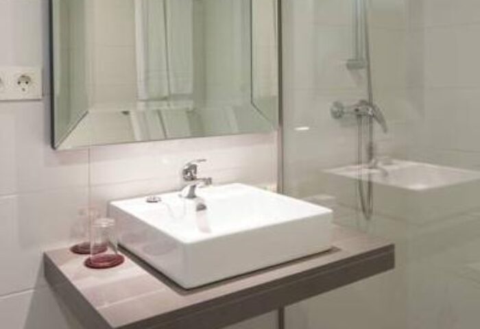 AxelBeach Ibiza bathroom. Modern sink, mirror, and shower in this gay-friendly, adults-only suite. Perfect for a relaxing spa getaway.
