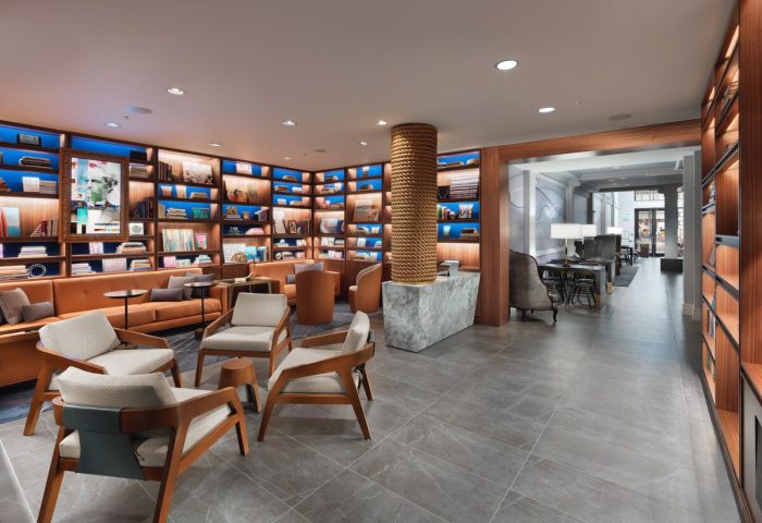 Axiom Hotel's stylish lobby. Gay-friendly hotel with library-themed lounge, comfortable seating, and modern design. A welcoming space for travelers.