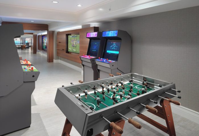 Axiom Hotel's gay-friendly game room features foosball, arcade games, and TVs. A fun space for guests to relax and enjoy their stay.