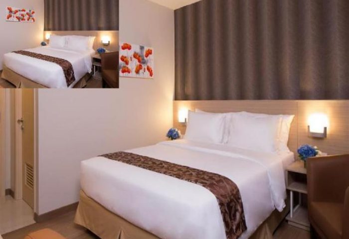 Ayaka Suites hotel room. Gay-friendly hotel with a queen bed, brown accents, and modern decor. A great place for gay travel.