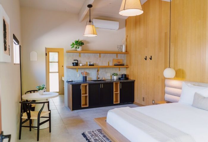 Azure Sky Hotel Adults Only gay-friendly room. Kitchenette, dining table, and bed in a modern room. Great for gay travel.