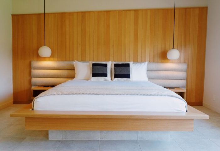 Azure Sky Hotel Adults Only bedroom. Modern design, wood paneling, platform bed, and pendant lights. Gay-friendly hotel for gay men travel.
