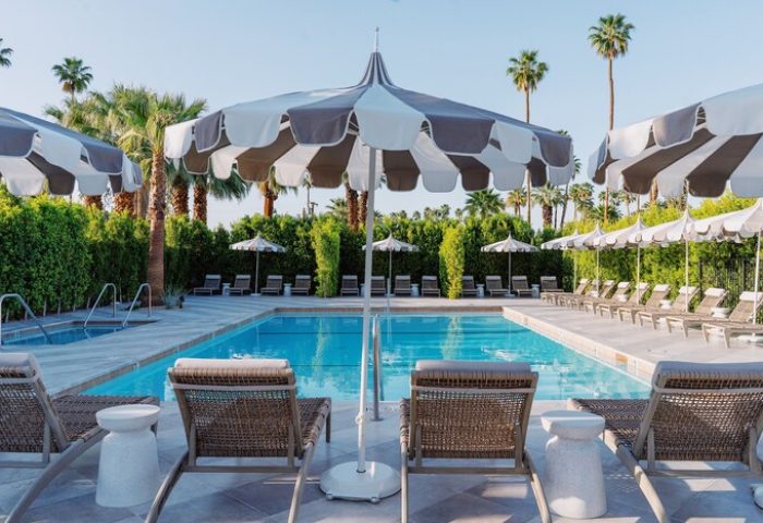 Azure Sky Hotel Adults Only pool area. Gay-friendly hotel with lounge chairs, umbrellas, and palm trees. Relaxing vacation for gay men.