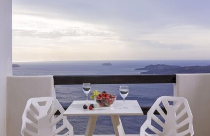 Azzurro Suites, a gay-friendly hotel. Balcony view with fruit, water, and sea. Perfect gay travel destination.
