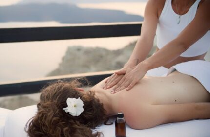 Azzurro Suites gay-friendly hotel: Man receiving a massage overlooking the sea. Relaxing wellness treatment at this gay travel destination.