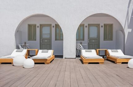Azzurro Suites gay-friendly hotel. Deck with sunbeds outside rooms with arched entrances. Modern design, perfect for gay travel.