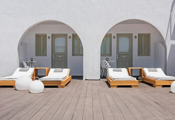 Azzurro Suites gay-friendly hotel. Deck with sunbeds outside rooms with arched entrances. Modern design, perfect for gay travel.