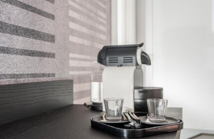 B&B First Floor: Coffee maker and glasses on a tray in a gay-friendly hotel room. Modern design, perfect for gay men travel.
