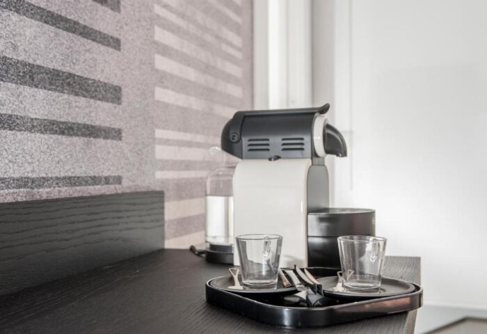 B&B First Floor: Coffee maker and glasses on a tray in a gay-friendly hotel room. Modern design, perfect for gay men travel.
