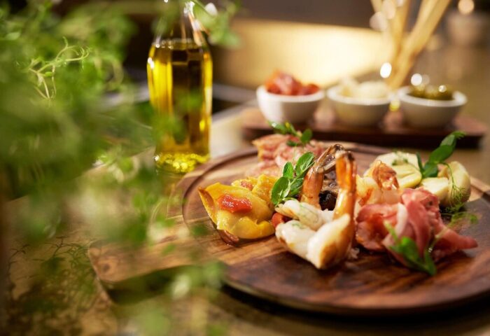 BEYOND by Geisel gay-friendly hotel food: Appetizers with shrimp, meat, ravioli, and olive oil. Gay travel dining experience.