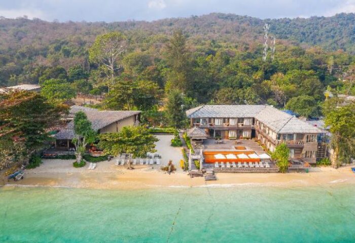 Baan Ploy Sea, gay-friendly hotel. Beachfront view of the hotel with pool, lounge chairs, and ocean. Tropical paradise for gay travelers.