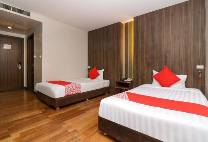 Bally Suite Silom hotel room with two beds. Gay-friendly hotel room features modern decor and comfortable bedding for a relaxing stay.