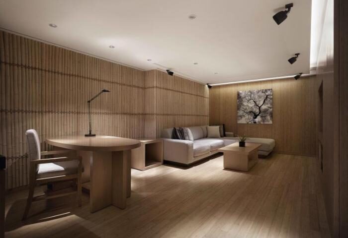 Banyan Tree Club & Spa Seoul suite interior. Gay-friendly hotel room with desk, sofa, and minimalist design. A luxury travel experience.