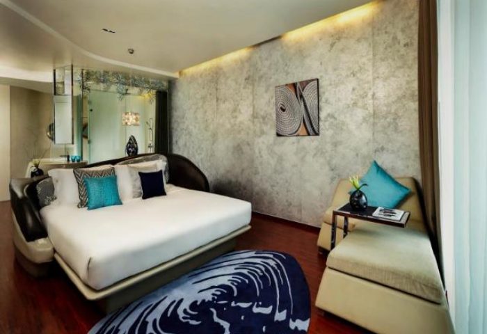 Gay-friendly hotel Baraquda Pattaya Mgallery room. Modern design with bed, seating area, and stylish decor. Upscale gay travel in Thailand.